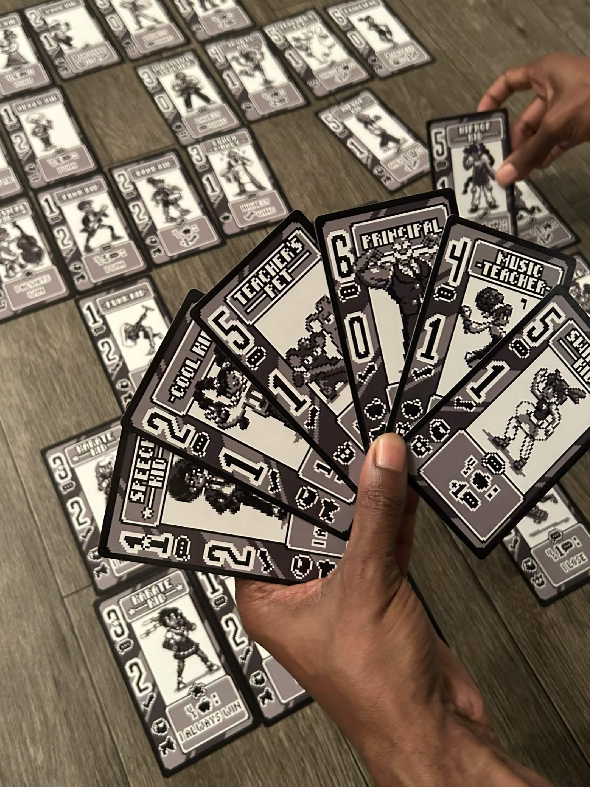 A player holding a hand of Your Class Rep cards above the cards laid out for deck building.